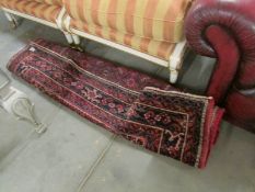 A dark red patterned rug.