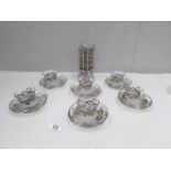 12 glass coffee cups and saucers with white metal decoration.