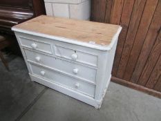 A 2 over 2 painted pine chest of drawers.