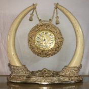 A decorative gilded clock with battery movement,.