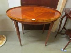 An oval mahogany inlaid occasional table.