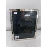 A silver photograph frame hall marked Carr's of Sheffield 1996. Approximately 23.5 x 28.5 cm (9.