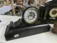 A black slate mantel clock, both springs ok but wound to limit, (no key).