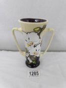 A Moorcroft trial loving cup, white orchid design.