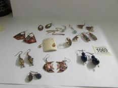 Twelve pairs of assorted pendant earrings including some enamelled.