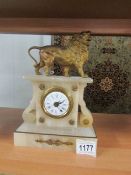 A French alabaster mantle clock surmounted lion.