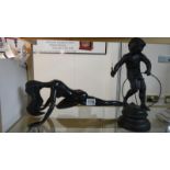 A spelter figure of a boy playing with a hoop together with a posing nude lady figure.