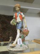 A Capo-di-Monte figurine of a boy fruit seller.