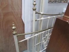 A brass and cast bed surround.