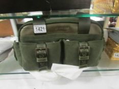 A boxed moss green Longchamp handbag.