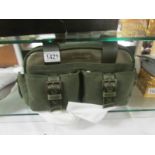 A boxed moss green Longchamp handbag.