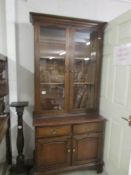 A mahogany bookcase on cupboard base with glazed doors to top..