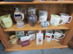 2 shelves of assorted brewery jugs etc.