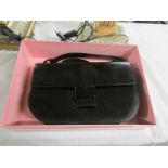 A boxed black patent leather Kurt Geiger handbag with shoulder strap.