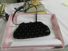 A Lulu Guiness black velvet clutch bag.