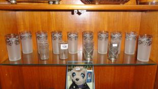 10 glass tumblers with white metal decoration and 2 pairs of smaller tumblers also with white metal