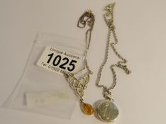 A silver amber Celtic pendant and a circular pendant, both on chains,.