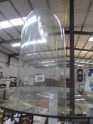 A glass dome for figure or taxidermy.