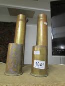 A pair of brass pom-pom mark 1 shell cases and a pair of brass six pounder shell cases.