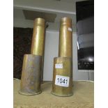 A pair of brass pom-pom mark 1 shell cases and a pair of brass six pounder shell cases.