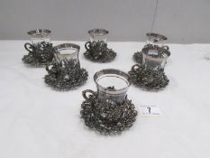 A set of 6 glass coffee cups with metal decoration and metal saucers.