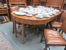 A burr walnut veneer circular extending drum/dining table with 2 leaves.