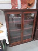 A mahogany glazed bookcase.