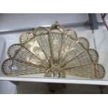 A brass fan fire screen.