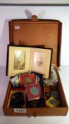 A leather case containing commemorative medallions, Victorian photograph book, silver cuff links,