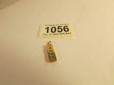 A 9ct gold ingot pendant.