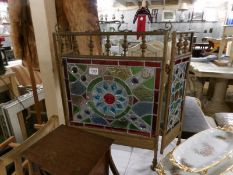 A Victorian 3 fold brass fire screen with leaded and stained glass panels.