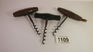 3 vintage corkscrews, one with brush end.