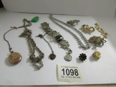 A mixed lot of vintage jewellery including coin style bracelet.