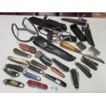 A collection of assorted penknives, pocket knives, lighters and catapults including Marbles, Soker,