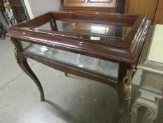 A mahogany display table, top glass needs fixing back in frame and one small side pane is missing.