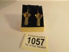 A pair of screw back earrings marked 14ct RG. (rolled gold).