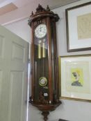 A mahogany twin weight Gastorr wall clock.