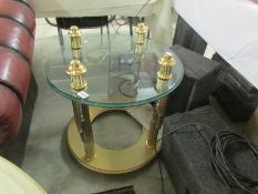 A glass top coffee table with gilded base.