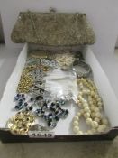 A mixed lot of costume jewellery including nurse's belt buckle, bangles, evening bag etc.