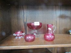 5 pieces of cranberry glass.