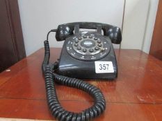 A black dial telephone.