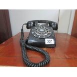 A black dial telephone.