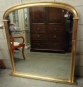 A gilt framed overmantel mirror.