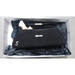 A boxed black rectangular Strutt handbag with silver coloured handle.