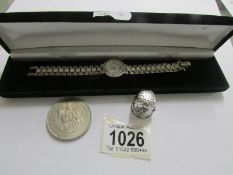 A ladies silver bracelet wrist watch, a crown and a thimble.