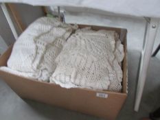 A box of crocheted blankets etc.