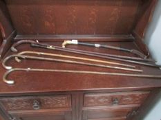 5 walking sticks (some with silver mounts and a riding crop/whip.