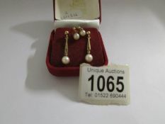 Two pairs of gold and cultured pearl earrings.