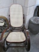A rocking chair with cane seat and back.