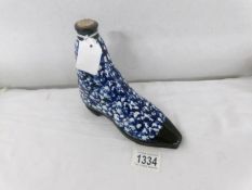 An unusual pottery decanter in the shape of a boot.